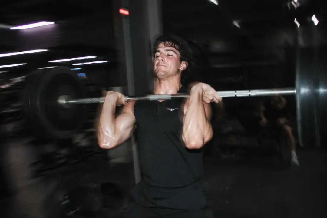 Un atleta hace una cargada con barra